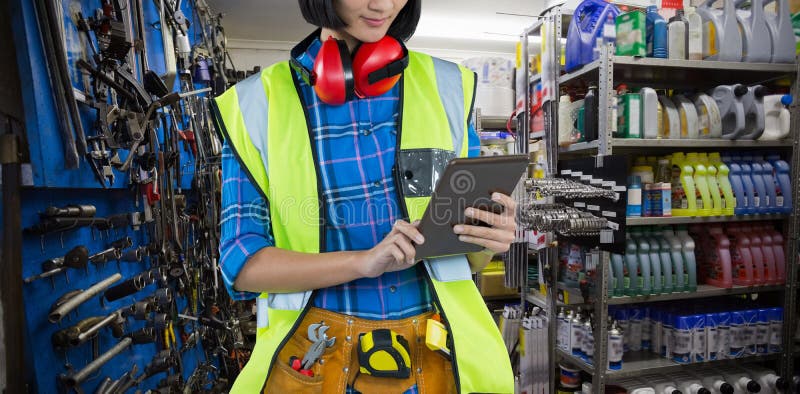 Composite image of female architect using digital tablet stock image Composite image of female architect using digital tablet stock image
