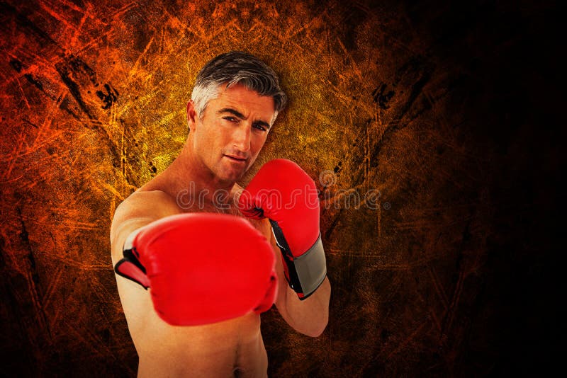 Composite Image of Fit Man Punching with Boxing Gloves Stock Image