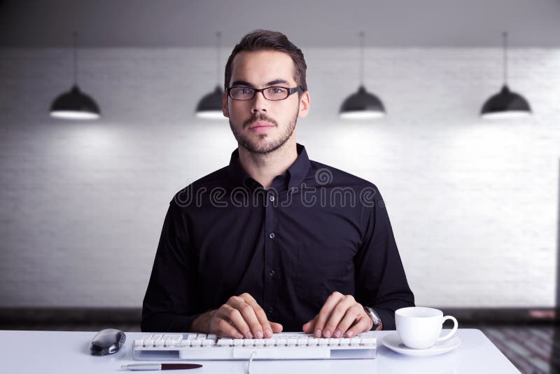 Composite image of focused businessman typing on keyboard royalty free stock photos