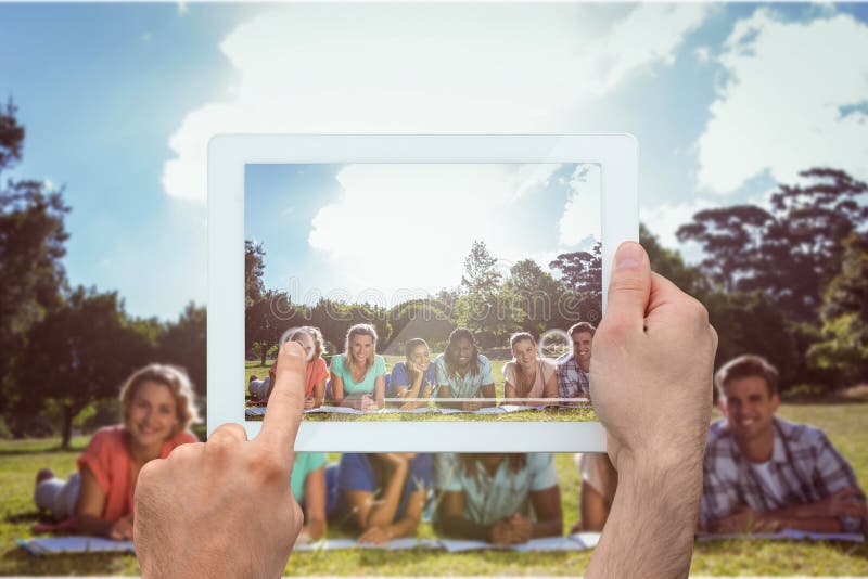 Composite image of hand holding tablet pc stock photo