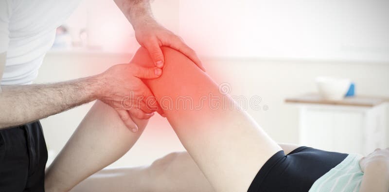 Composite image of handsome young physical therapist giving a leg massage