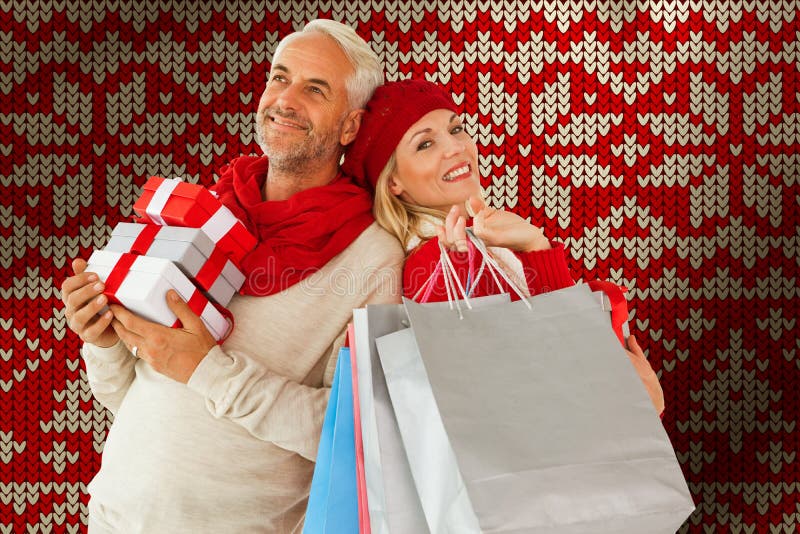 Composite image of happy festive couple with gifts and bags