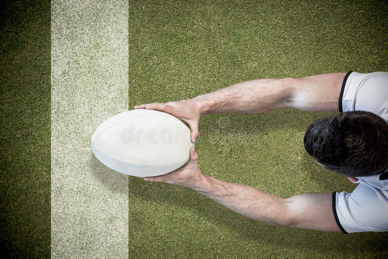 Composite Image of High Angle View of Man Holding Rugby Ball with Both Hands Stock Image Image