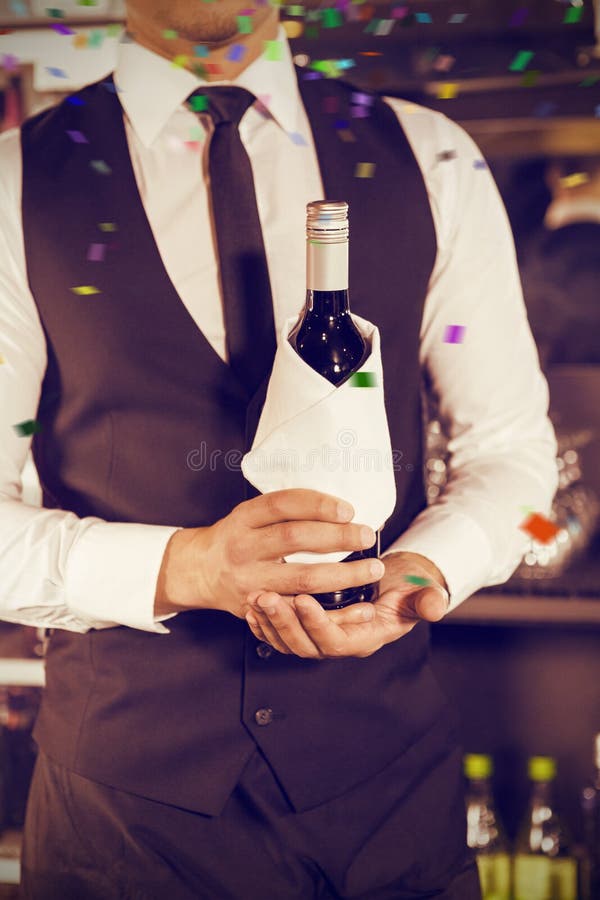 Composite Image of Midsection of Bartender Holding Wine Bottle Stock