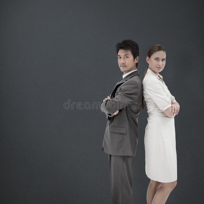Composite image of portrait of business people standing back-to-back royalty free stock photography