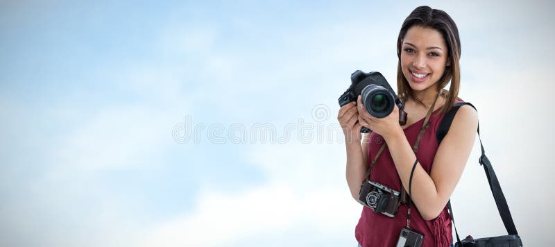 Composite image of portrait of happy young woman holding digital camera stock photography Composite image of portrait of happy young woman holding digital camera stock photography