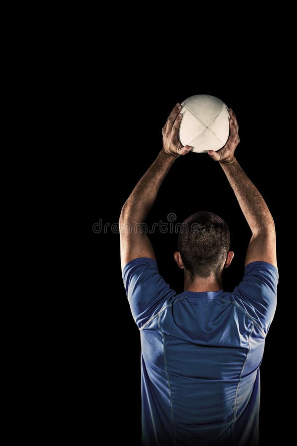 Composite Image of Rear View of Sports Player Throwing Ball Stock Photo