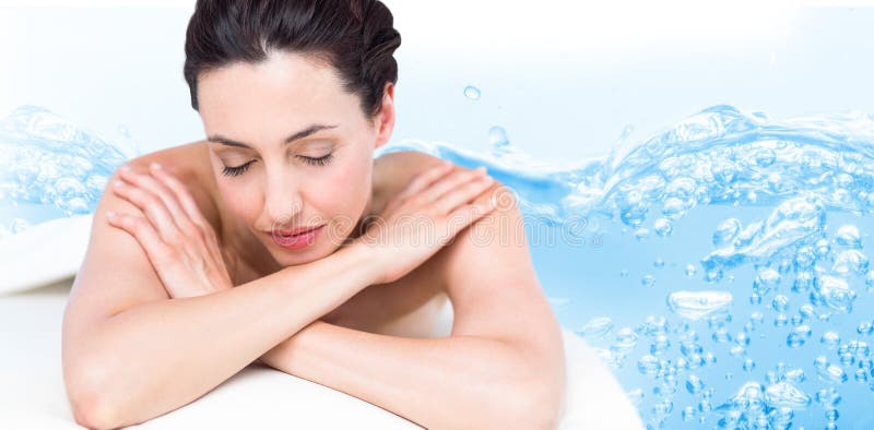 Composite image of smiling brunette relaxing on massage table royalty free stock photos Composite image of smiling brunette relaxing on massage table royalty free stock photos