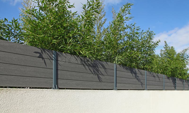 Composite wood palisade on a garden fence wall
