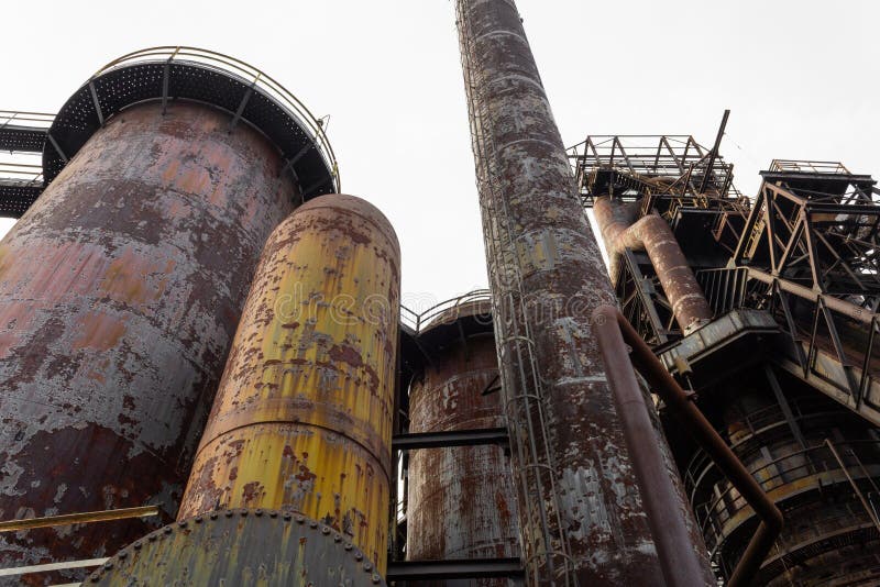 Composition of blast furnaces and smokestacks in an old steel mill, rust and peeling paint patinas royalty free stock image Composition of blast furnaces and smokestacks in an old steel mill, rust and peeling paint patinas royalty free stock image