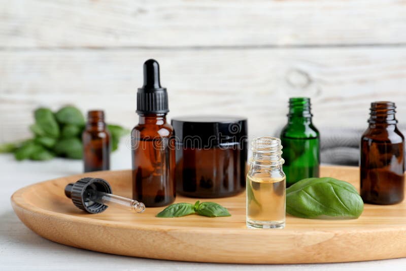 Composition with Bottles of Essential Oils and Basil Stock Photo
