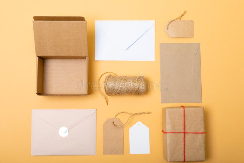 Composition of Boxes, Envelopes and Gift Tags on Yellow Background