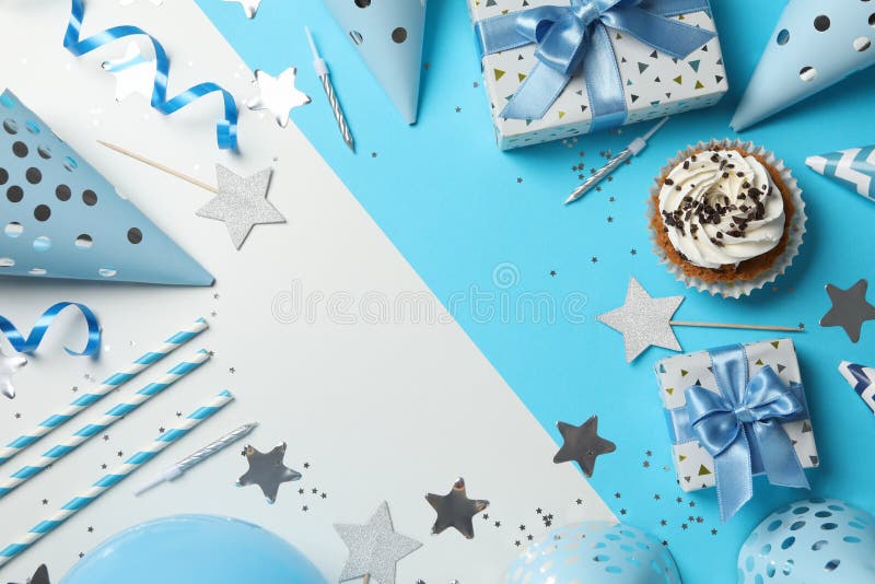 Composition with cupcake and birthday accessories on two tone background, space for text