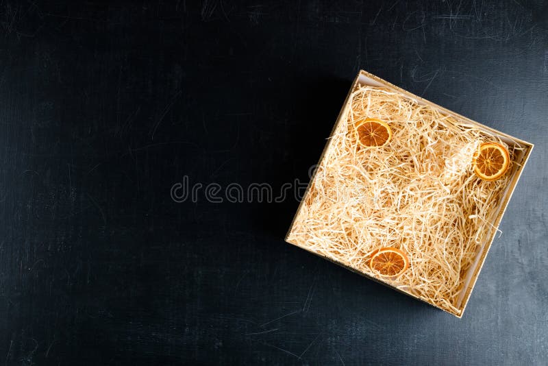 Composition with decorative straw and citrus in a box on dark ba stock images
