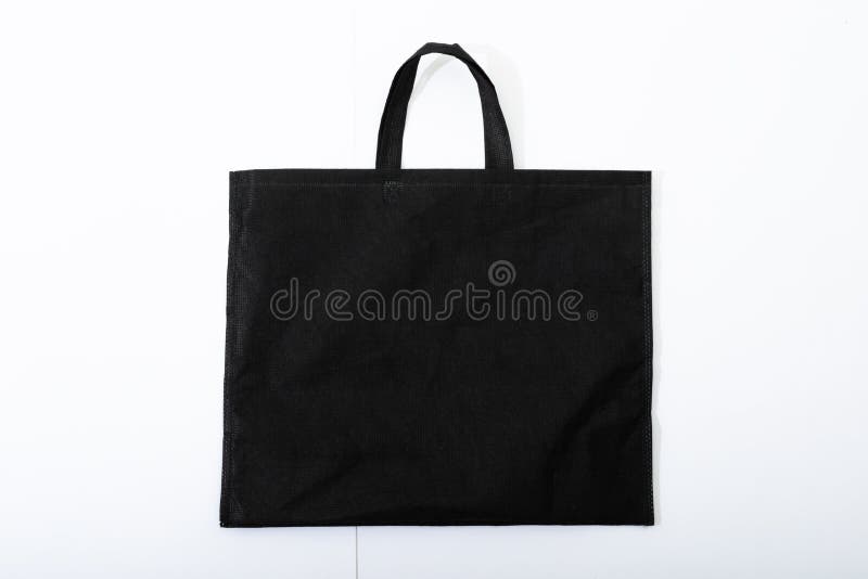 Composition of Empty Black Canvas Shopping Bag Lying Flat on White