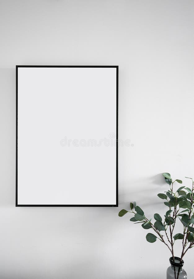 Composition of empty black wooden frame install on white painted wall with artificial plant on the corner / interior design / isol royalty free stock photography Composition of empty black wooden frame install on white painted wall with artificial plant on the corner / interior design / isol royalty free stock photography