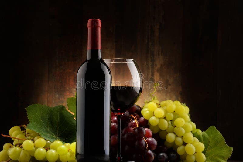 Composition with glass, bottle of red wine and fresh grapes stock photo Composition with glass, bottle of red wine and fresh grapes stock photo