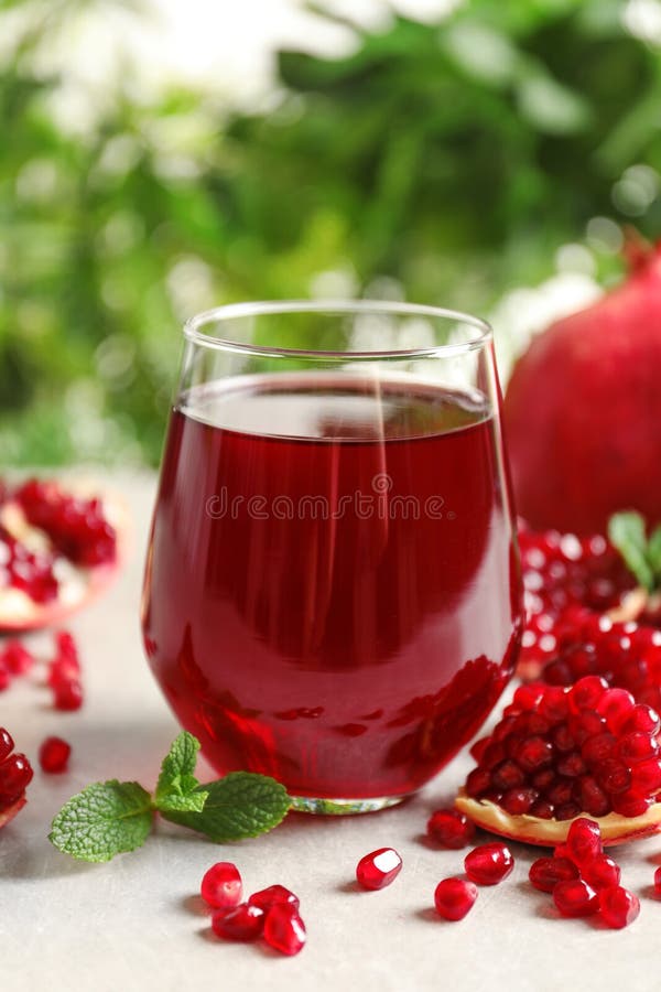 Composition with glass of fresh pomegranate juice