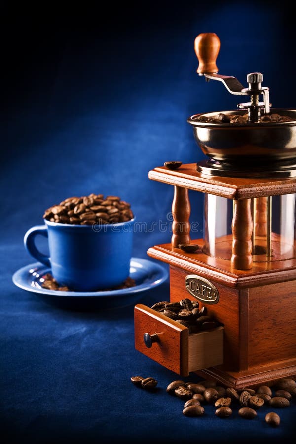 Composition of grinder and cup with coffee grain