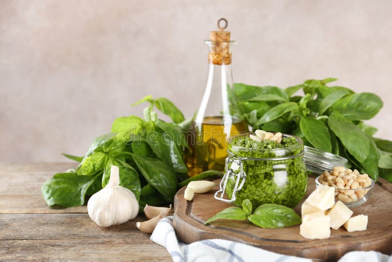 Composition with Jar of Pesto Sauce and Ingredients on Table. Stock