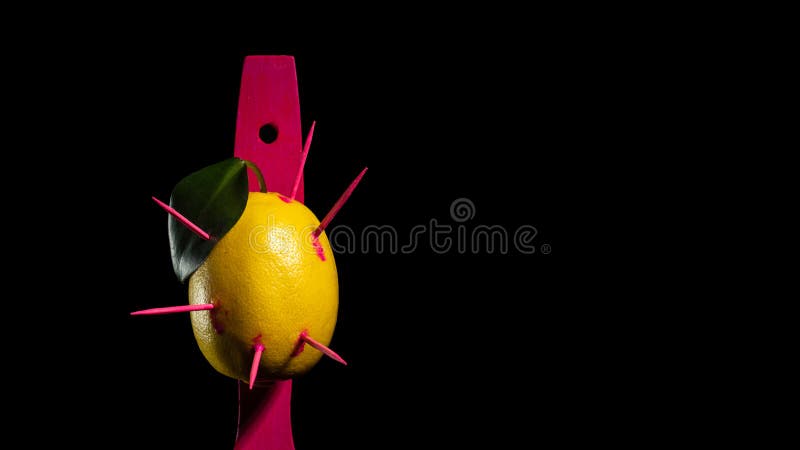 Composition with lemon and arrows on a black background royalty free stock image