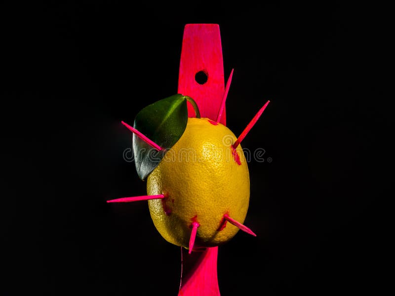 Composition with lemon and arrows on a black background royalty free stock photography