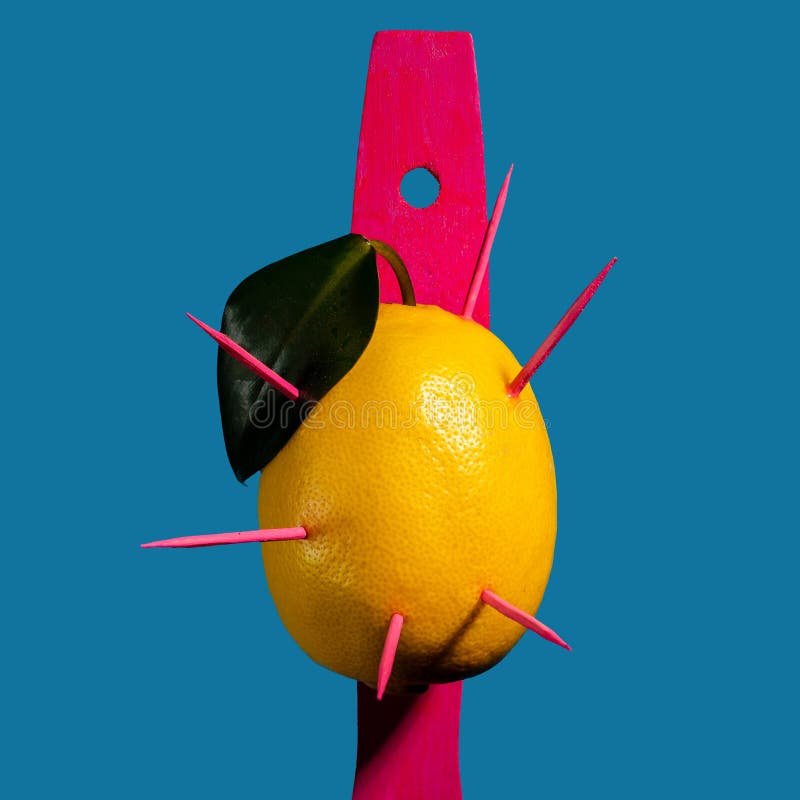 Composition with lemon and arrows on a blue background stock photos