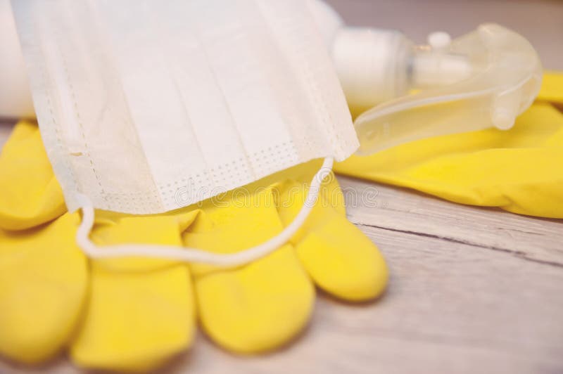 Composition of a Pair of Yellow Latex Gloves with White Plastic Bottle