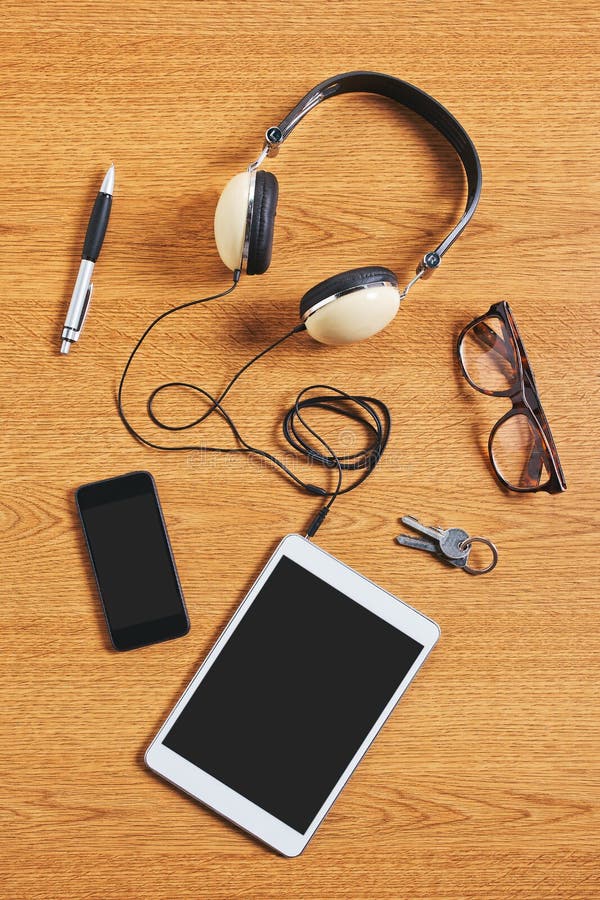 Composition of Tablet, Phone and Headphones on a Desk. Stock Image