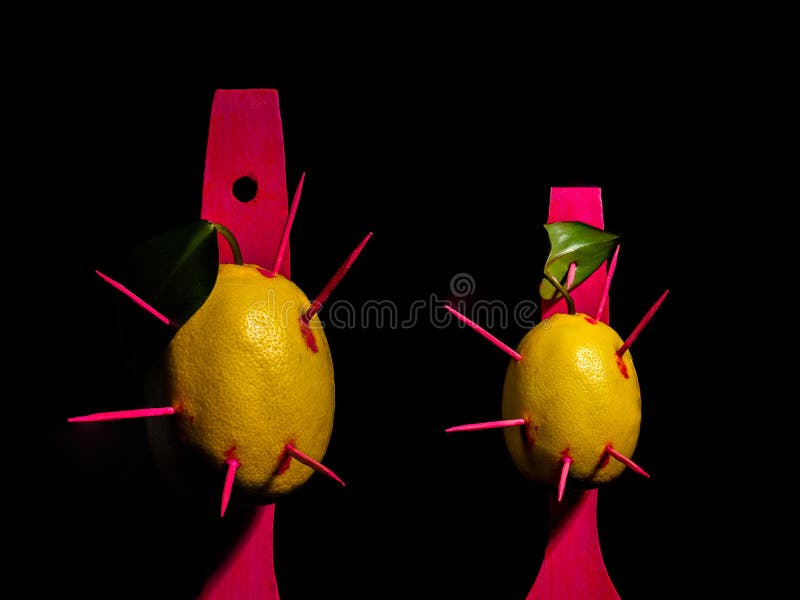 Composition with two lemons and arrows on a black background royalty free stock photography