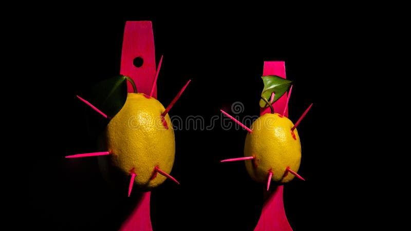 Composition with two lemons and arrows on a black background stock images
