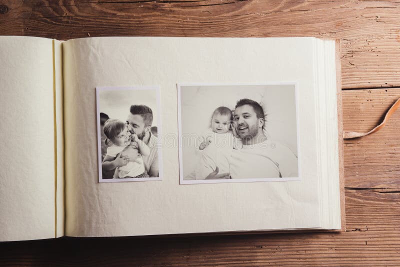 Fathers day composition - photo album with a black and white photos. Studio shot on wooden background. Fathers day composition - photo album with a black and white photos. Studio shot on wooden background.