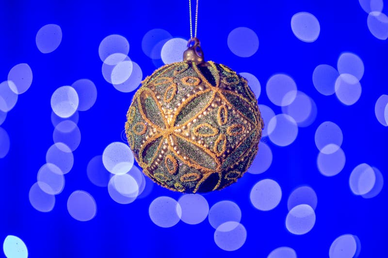 Christmas composition - Christmas tree toy on a blue background with bokeh 1. Christmas composition - Christmas tree toy on a blue background with bokeh 1