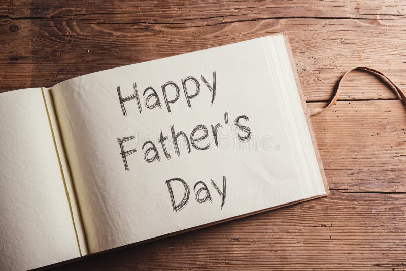 Fathers day composition - photo album with Happy fathers sign. Studio shot on wooden background. Fathers day composition - photo album with Happy fathers sign. Studio shot on wooden background.