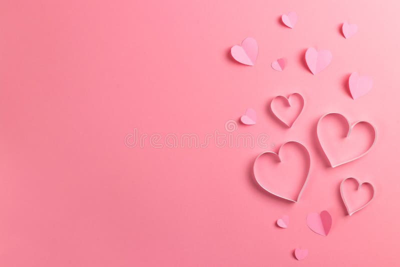 Composition for Valentine`s Day February 14th. Delicate pink background and pink hearts cut out of paper. Greeting card. Flat lay, top view, copy space. Composition for Valentine`s Day February 14th. Delicate pink background and pink hearts cut out of paper. Greeting card. Flat lay, top view, copy space