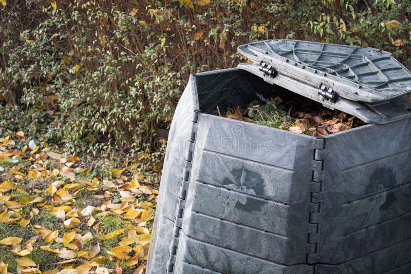 Composting bin for recycling kitchen and garden organic waste. Zero waste, sustainability and environmental protection concept stock image Composting bin for recycling kitchen and garden organic waste. Zero waste, sustainability and environmental protection concept stock image