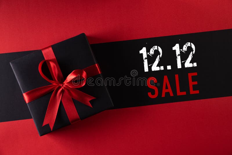 Online shopping of China, 12.12 singles day sale concept. Top view of black christmas boxes with red ribbon on black background with copy space for text 12.12 singles day sale. Online shopping of China, 12.12 singles day sale concept. Top view of black christmas boxes with red ribbon on black background with copy space for text 12.12 singles day sale