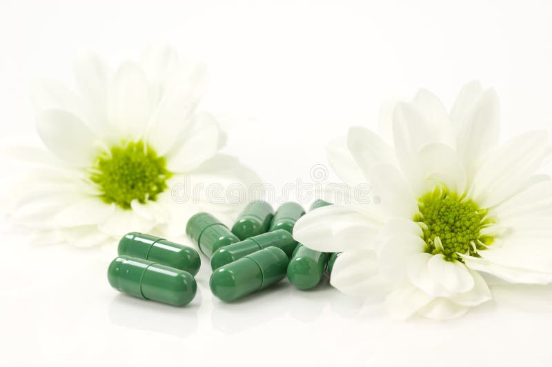 Vitamine pills from nature and two flowers. Vitamine pills from nature and two flowers