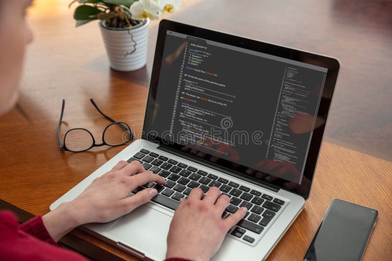 Computer code, software concept. Programmer working with a laptop, programming code on the screen, office background. Developing coding technologies. Programmer type code stock images, royalty-free photos and pictures
