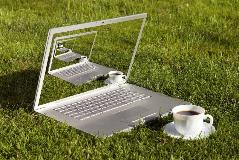 Computer and coffee on the grass