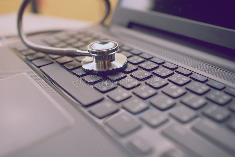 Computer or data analysis - Stethoscope over notebook keyboard stock photography
