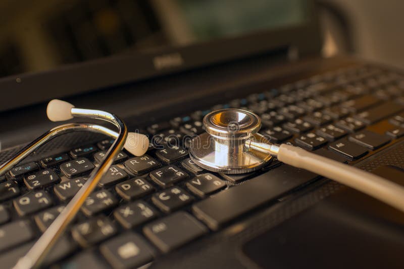 Computer or data analysis - Stethoscope over notebook keyboard royalty free stock image