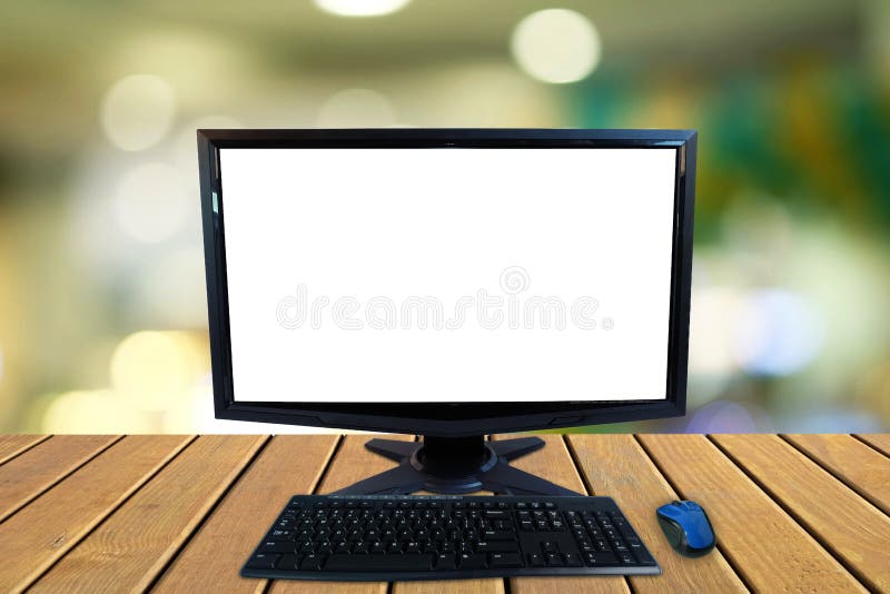 Computer desktop pc with blank screen and keyboard and wireless mouse on wooden floors with blurred colorful bokeh stock images Computer desktop pc with blank screen and keyboard and wireless mouse on wooden floors with blurred colorful bokeh stock images