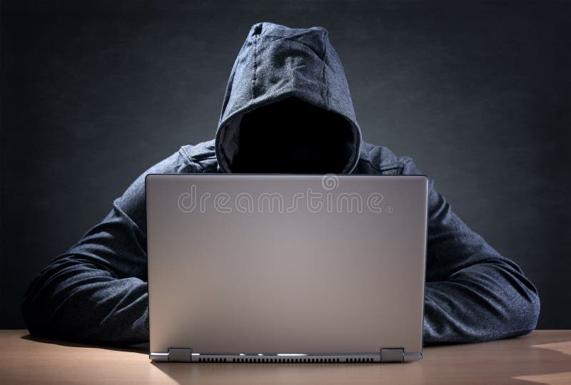 Computer hacker stealing data from a laptop royalty free stock image