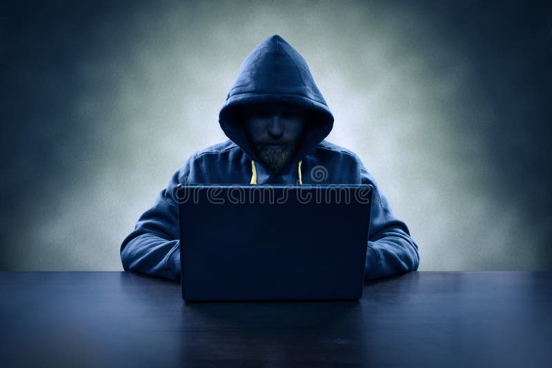 Computer hacker stealing information with laptop royalty free stock photography