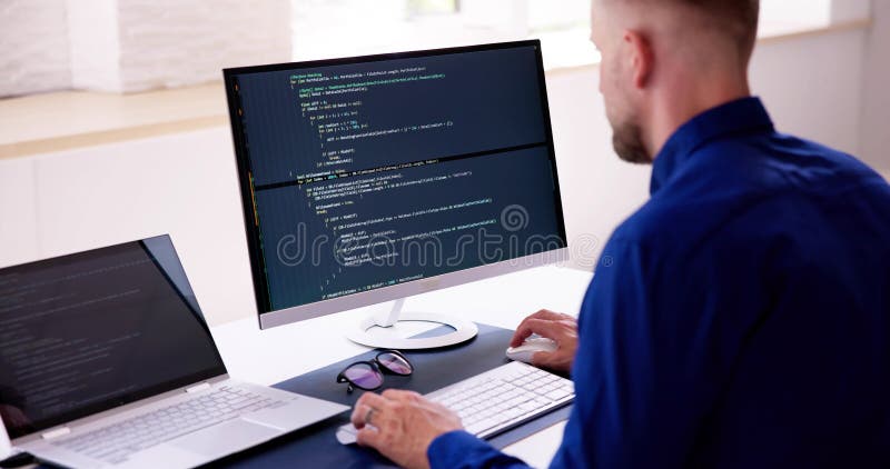 Computer Programmer Writing Program Code on Computer Stock Photo ...