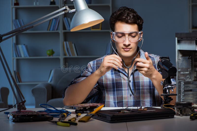 The computer repair concept with man inspecting with stethoscope stock image The computer repair concept with man inspecting with stethoscope stock image