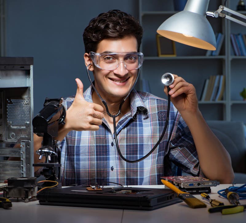 Computer Repair Concept with Man Inspecting with Stethoscope Stock