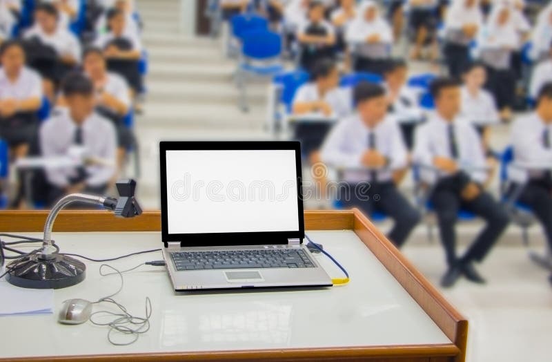 Computer on the Table and Group Students Blur Sitting in the a