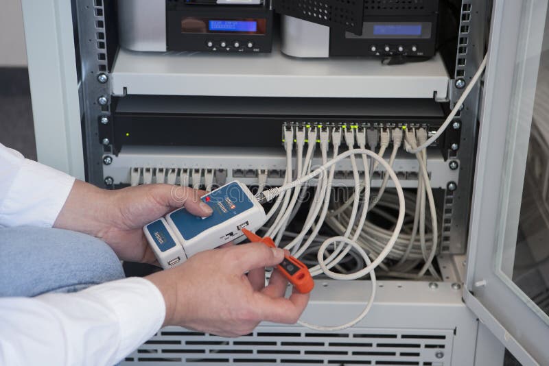 Computer technician. With a tester for a network Computer technician. With a tester for a network